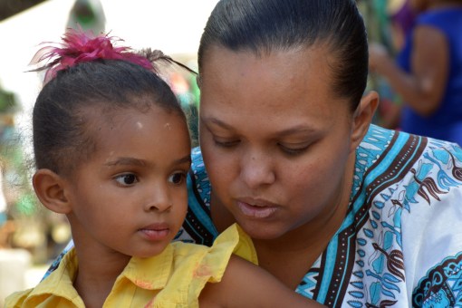A little girl at the sand drawing table.